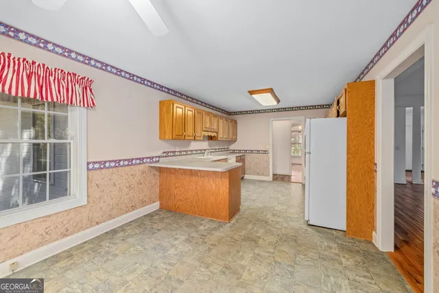 a view of a kitchen with a sink and a refrigerator