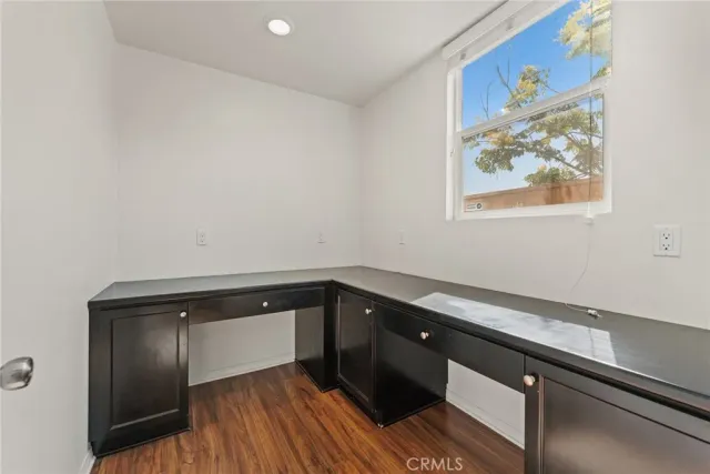 a kitchen with a sink and wooden floor
