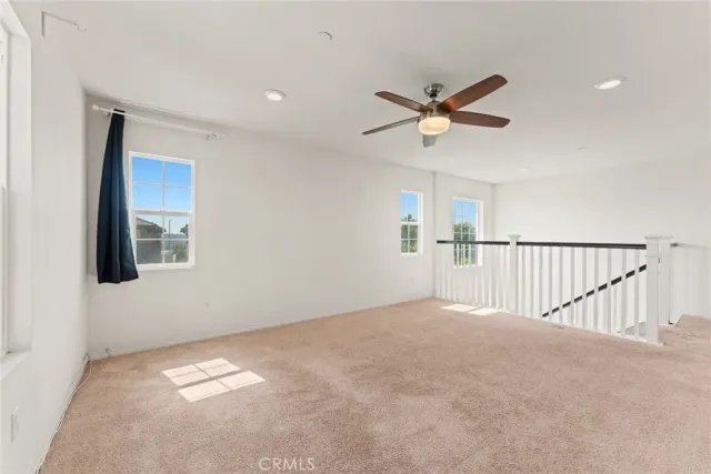 a view of a livingroom with a ceiling fan and window