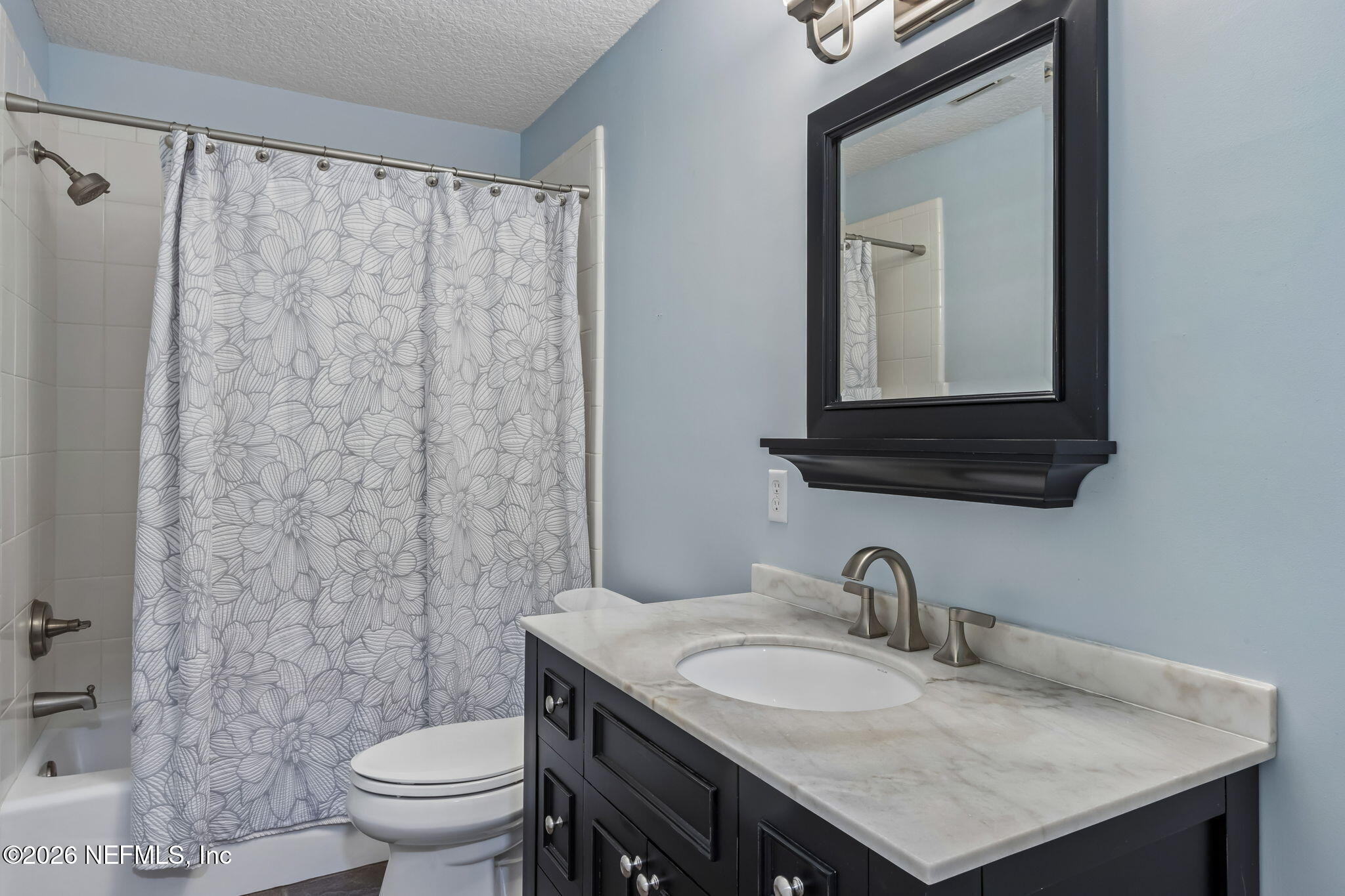 1877 Christopher Point Road South Jacksonville, FL 32217 - Photo 19 of 27 a bathroom with a granite countertop sink a toilet and a mirror