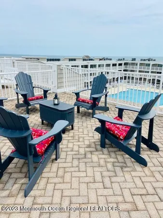 a living room with furniture a rug and a potted plant