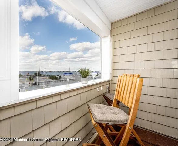 a view of a chair and table in the balcony