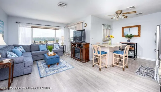 a living room with furniture a fireplace and a window