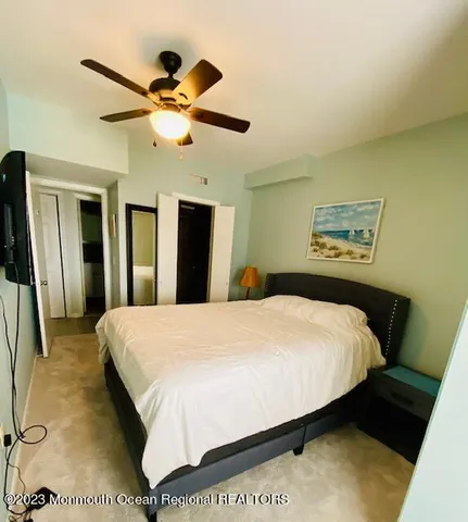 a bedroom with a bed and a large mirror