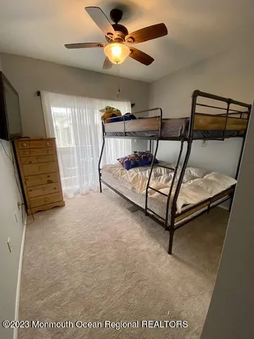 a bedroom with furniture and a ceiling fan