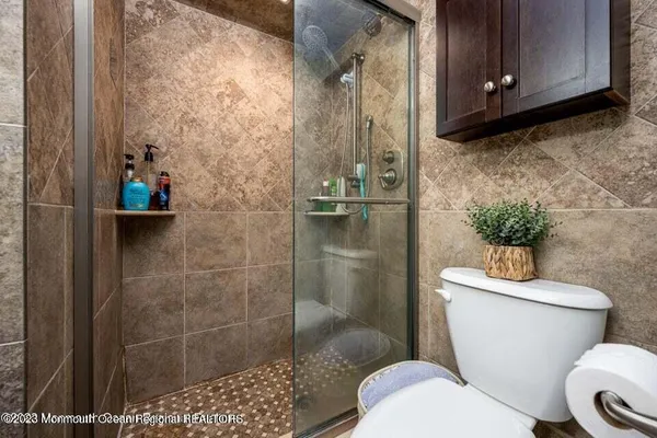 a white toilet sitting next to a bathroom sink