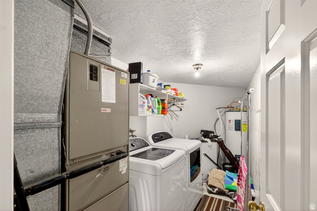 161 West 950 South, Unit Q1 St. George, UT 84770 - Photo 33 of 37 Laundry room featuring a textured ceiling, heating unit, washer and dryer, and electric water heater