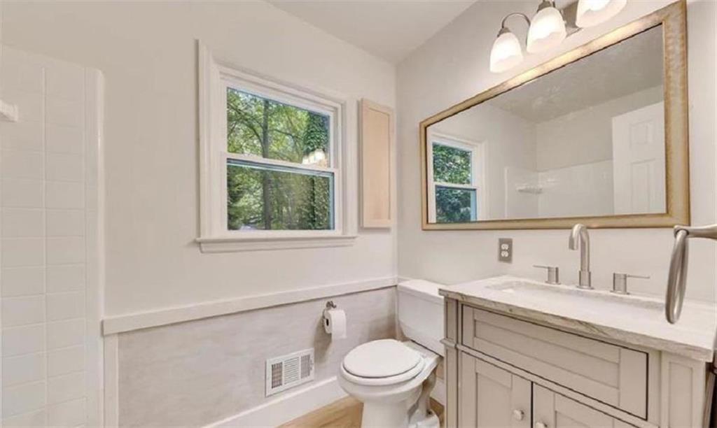 4520 Santa Fe Trail Southwest Atlanta, GA 30331 - Photo 15 of 19 a bathroom with a sink toilet a mirror and window