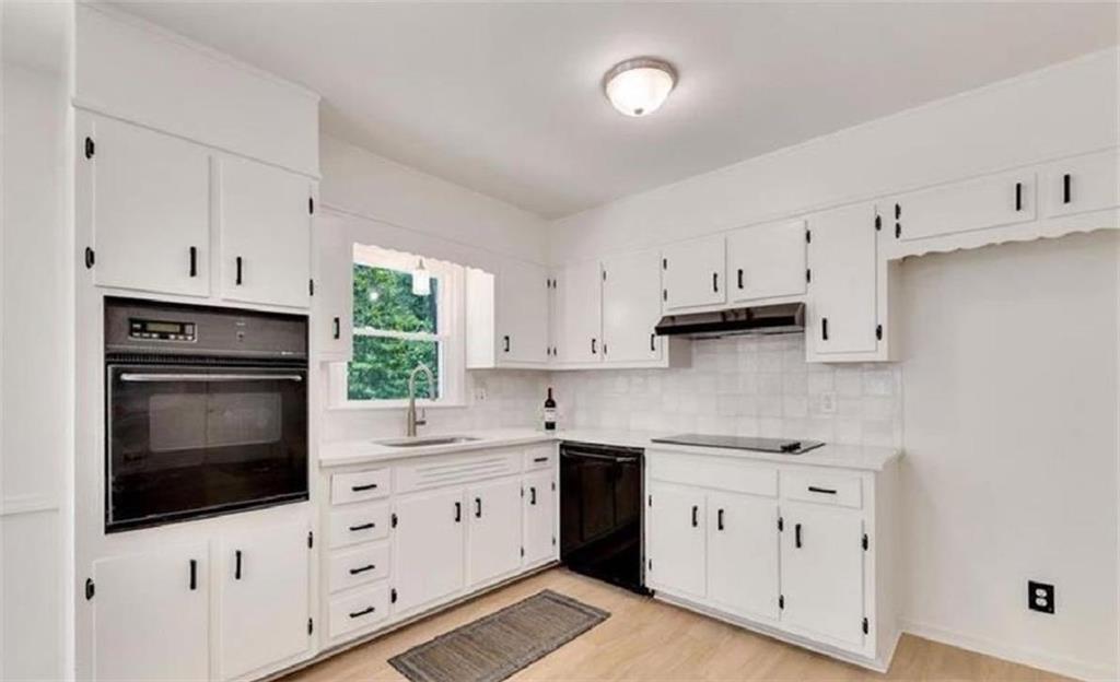 4520 Santa Fe Trail Southwest Atlanta, GA 30331 - Photo 5 of 19 a kitchen with cabinets appliances a sink and a window