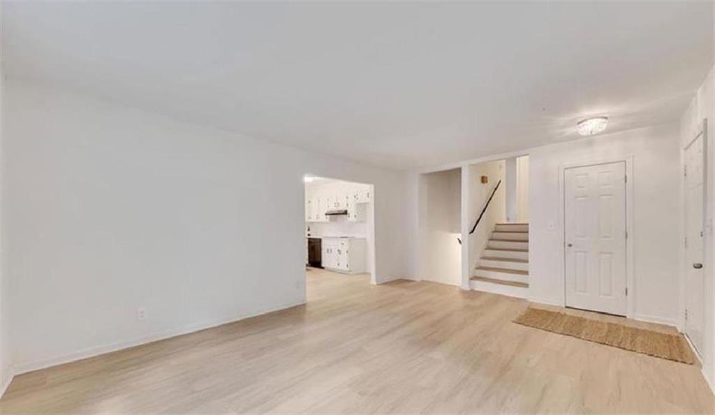 4520 Santa Fe Trail Southwest Atlanta, GA 30331 - Photo 8 of 19 an empty room with wooden floor and stairs