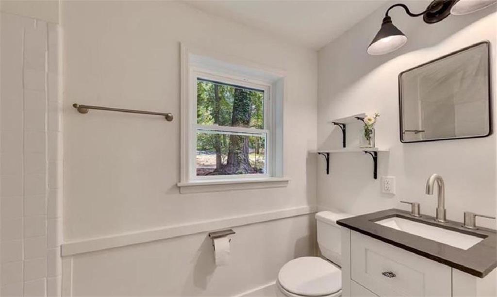 4520 Santa Fe Trail Southwest Atlanta, GA 30331 - Photo 9 of 19 a bathroom with a toilet sink and mirror