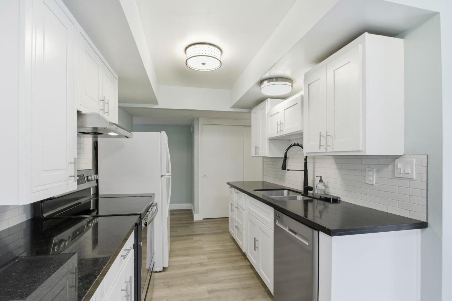 2100 Tiny Street Milpitas, CA 95035 - Photo 11 of 41 a kitchen with granite countertop a sink stainless steel appliances and cabinets