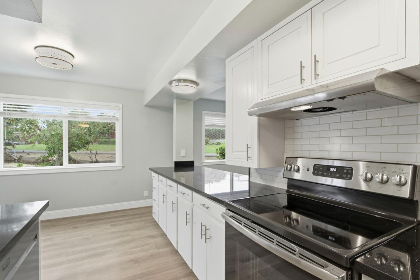 2100 Tiny Street Milpitas, CA 95035 - Photo 12 of 41 a kitchen with granite countertop a stove and a sink