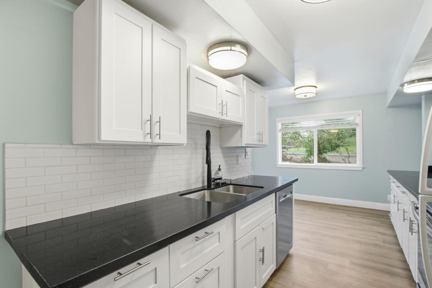 2100 Tiny Street Milpitas, CA 95035 - Photo 14 of 41 a kitchen with granite countertop a sink a stove and cabinets