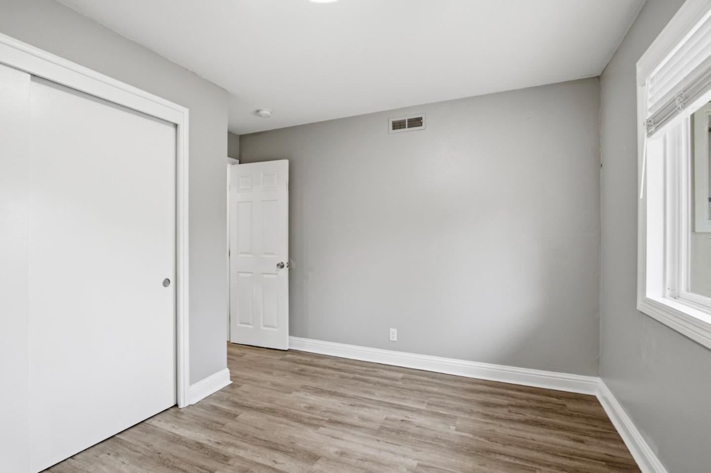 2100 Tiny Street Milpitas, CA 95035 - Photo 19 of 41 an empty room with wooden floor and windows