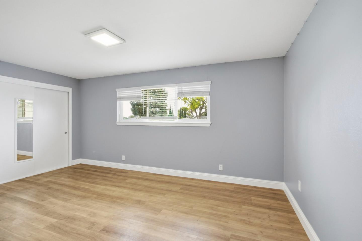 2100 Tiny Street Milpitas, CA 95035 - Photo 29 of 41 a view of an empty room with wooden floor and a window