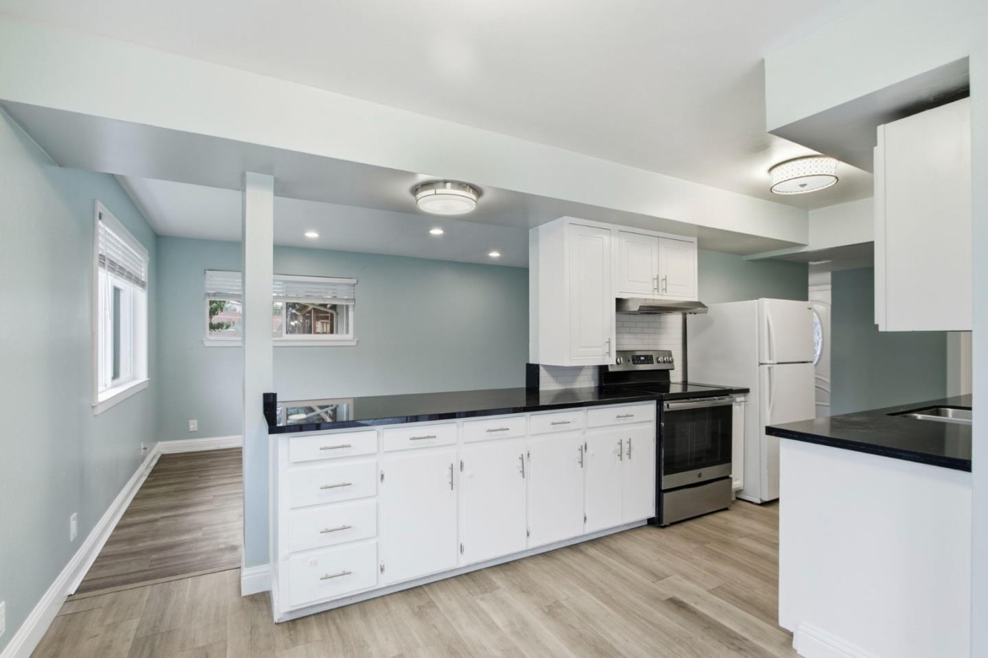 2100 Tiny Street Milpitas, CA 95035 - Photo 10 of 41 a kitchen with granite countertop a sink stove and refrigerator