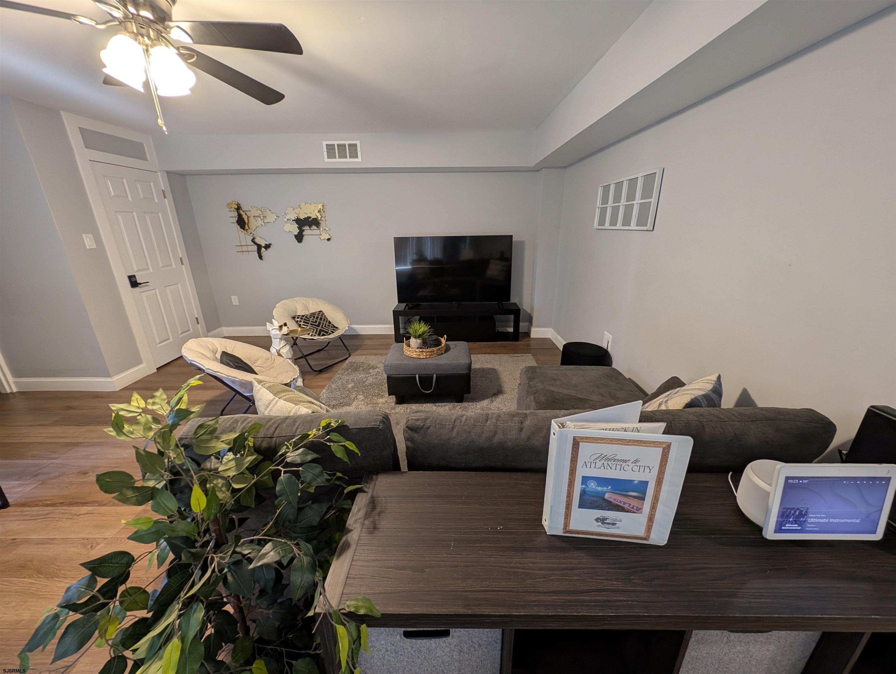 600 Pacific Avenue, Unit D102 Atlantic City, NJ 08401 - Photo 12 of 35 a living room with furniture and a flat screen tv