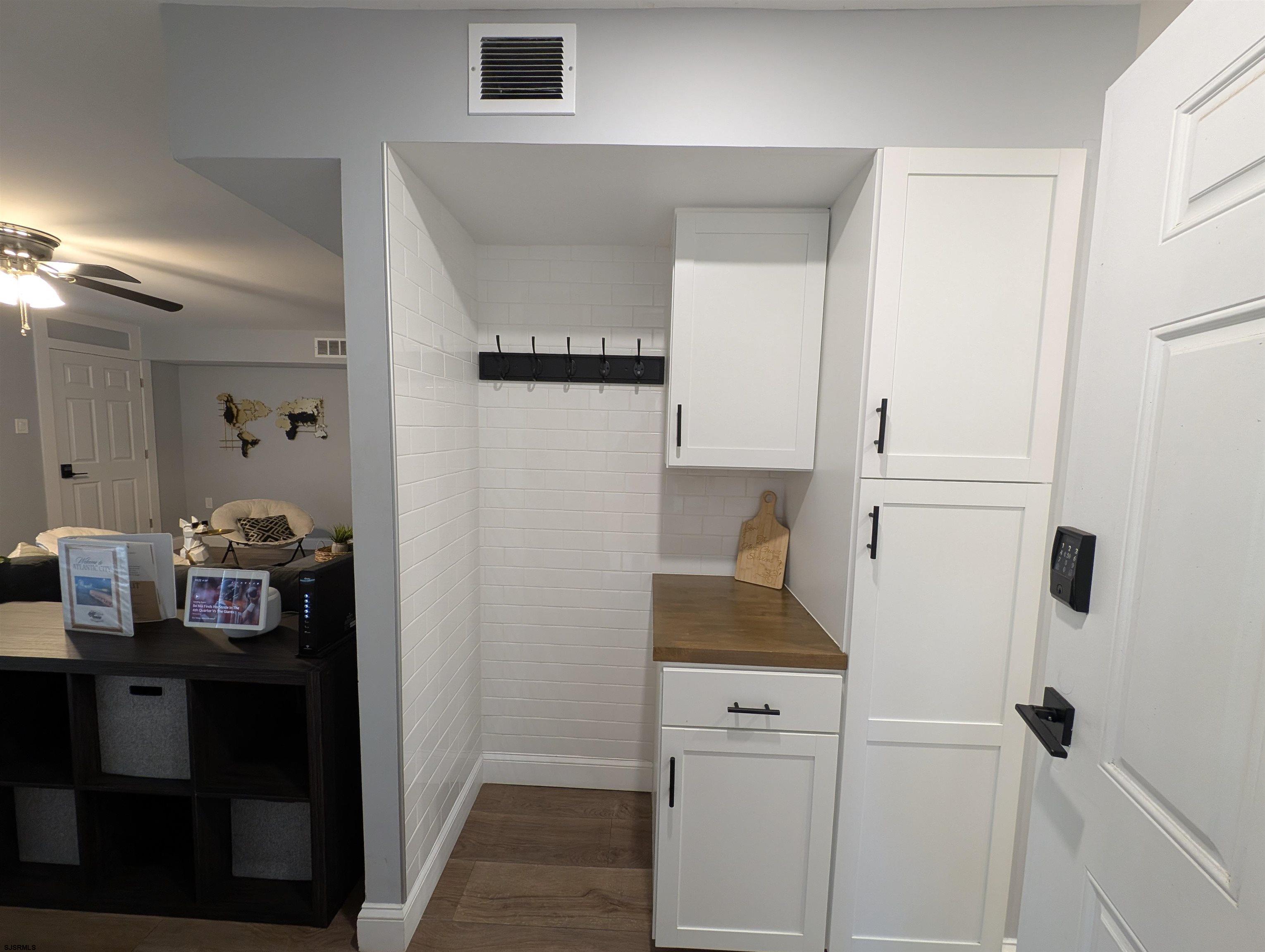 600 Pacific Avenue, Unit D102 Atlantic City, NJ 08401 - Photo 20 of 35 a kitchen with cabinets and a refrigerator