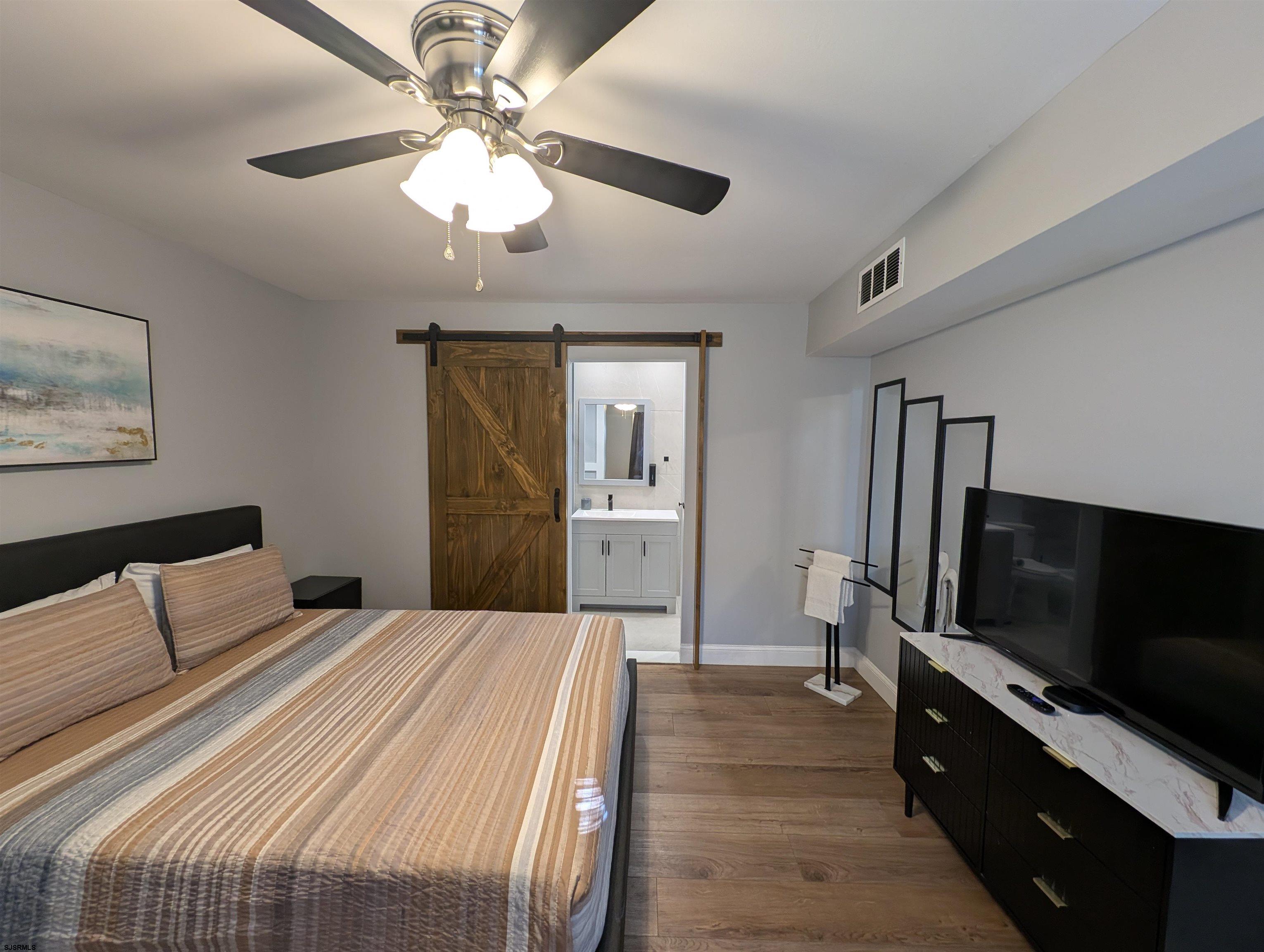 600 Pacific Avenue, Unit D102 Atlantic City, NJ 08401 - Photo 22 of 35 a bedroom with a bed and a flat screen tv