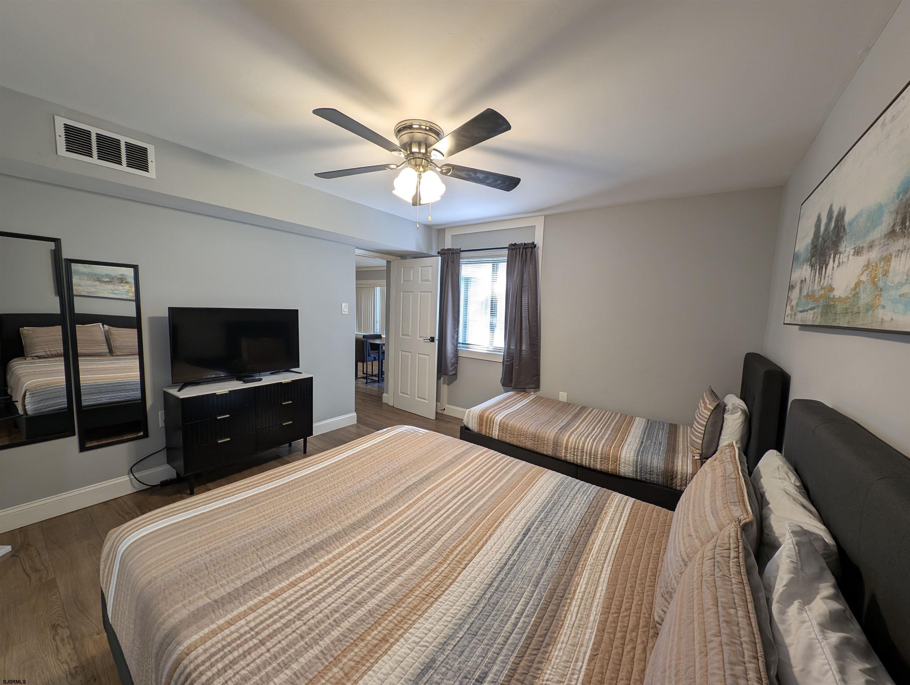600 Pacific Avenue, Unit D102 Atlantic City, NJ 08401 - Photo 23 of 35 a bedroom with a bed and a flat screen tv