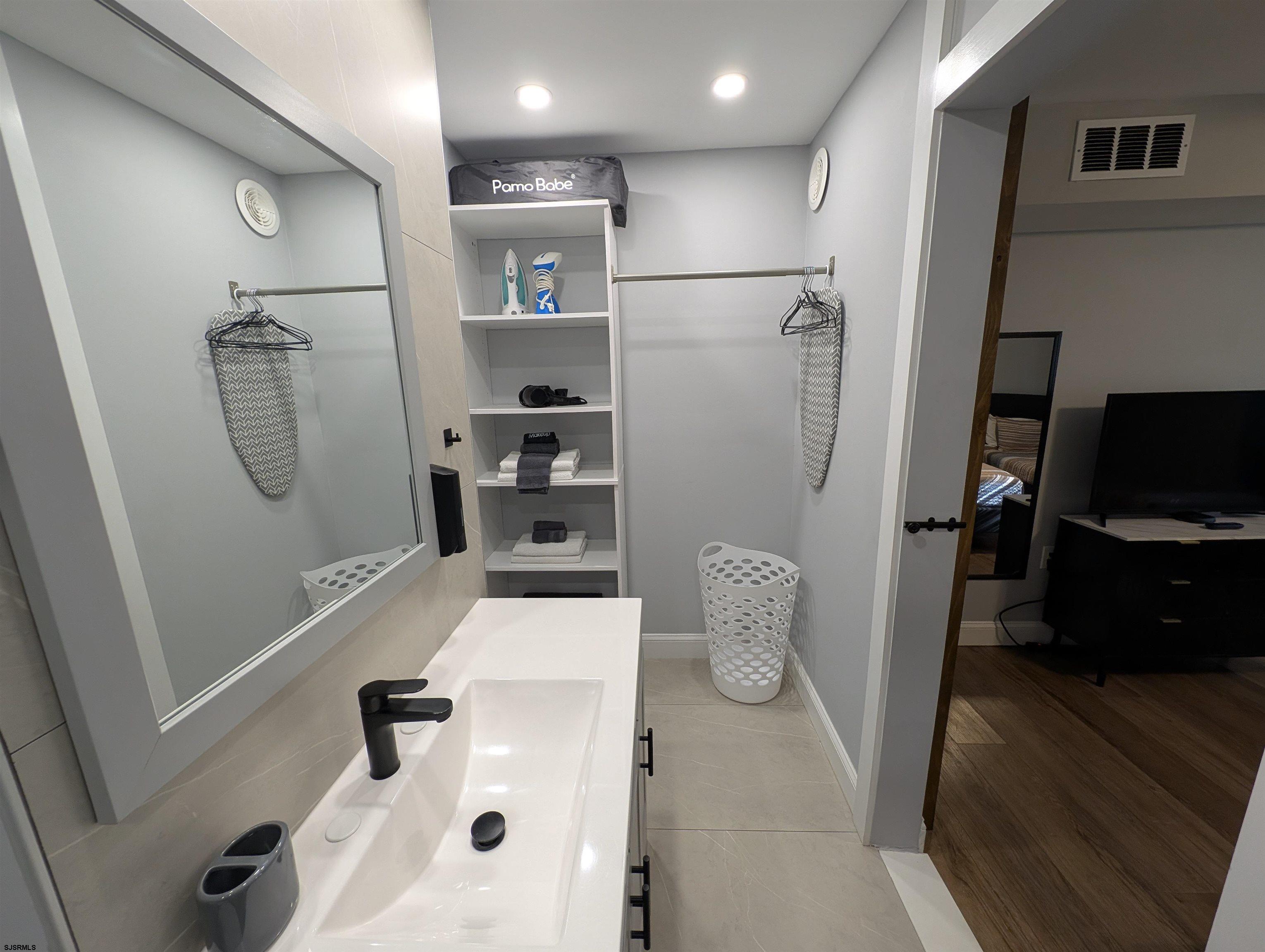 600 Pacific Avenue, Unit D102 Atlantic City, NJ 08401 - Photo 28 of 35 a view of walk in closet with clothes and shoes