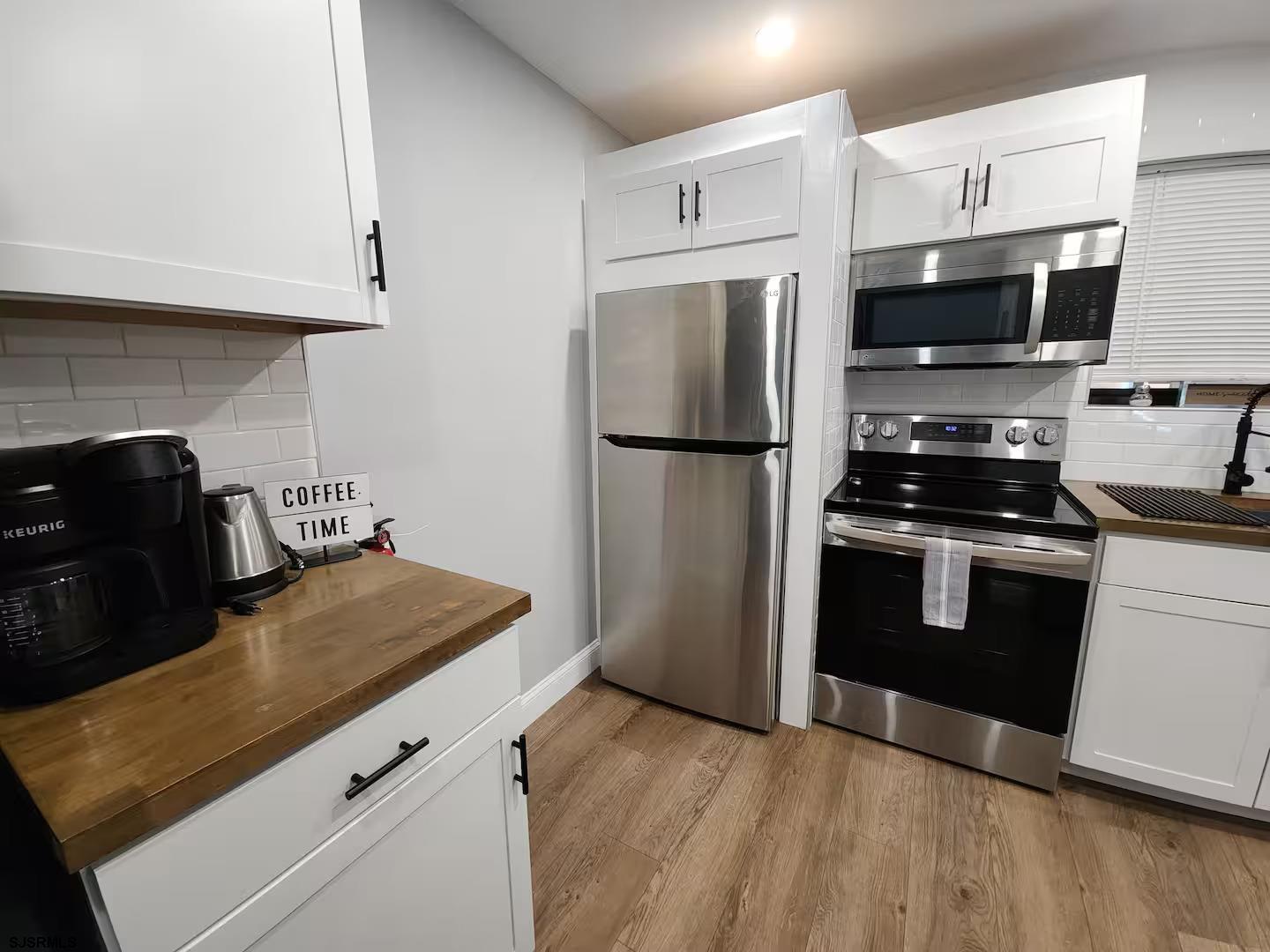 600 Pacific Avenue, Unit D102 Atlantic City, NJ 08401 - Photo 7 of 35 a kitchen with granite countertop a refrigerator stove and microwave