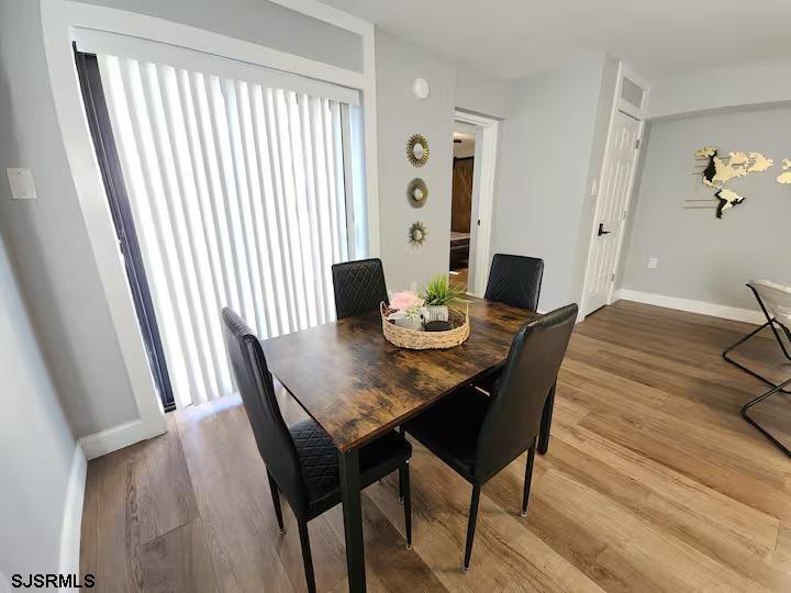 600 Pacific Avenue, Unit D102 Atlantic City, NJ 08401 - Photo 9 of 35 a view of a dining room with furniture and wooden floor
