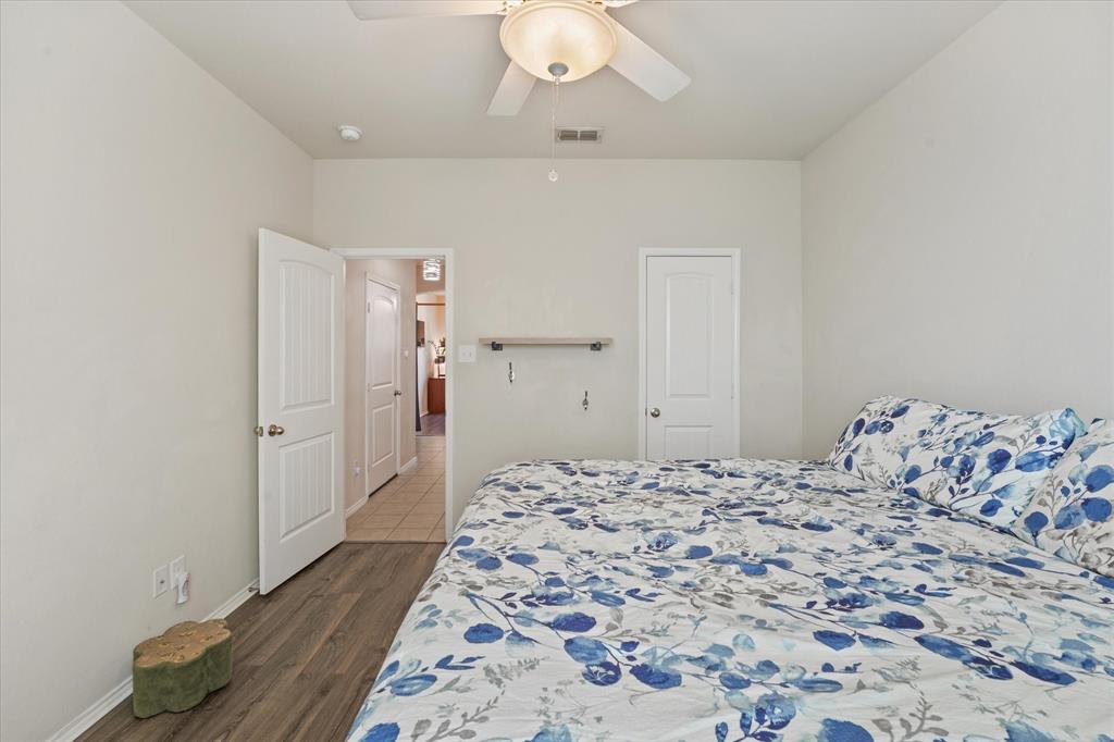 3801 Surf Street Denton, TX 76208 - Photo 17 of 29 Bedroom featuring a ceiling fan and dark wood-type flooring