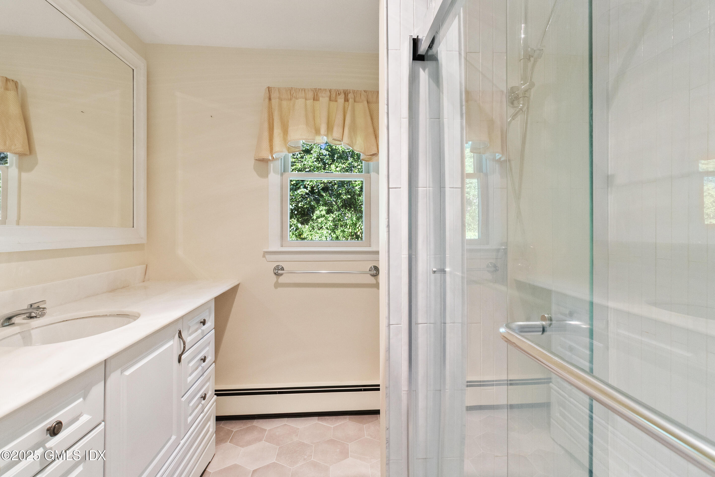 17 Cornwall Road Norwalk, CT 06850 - Photo 23 of 28 a bathroom with a sink and a mirror with bathtub