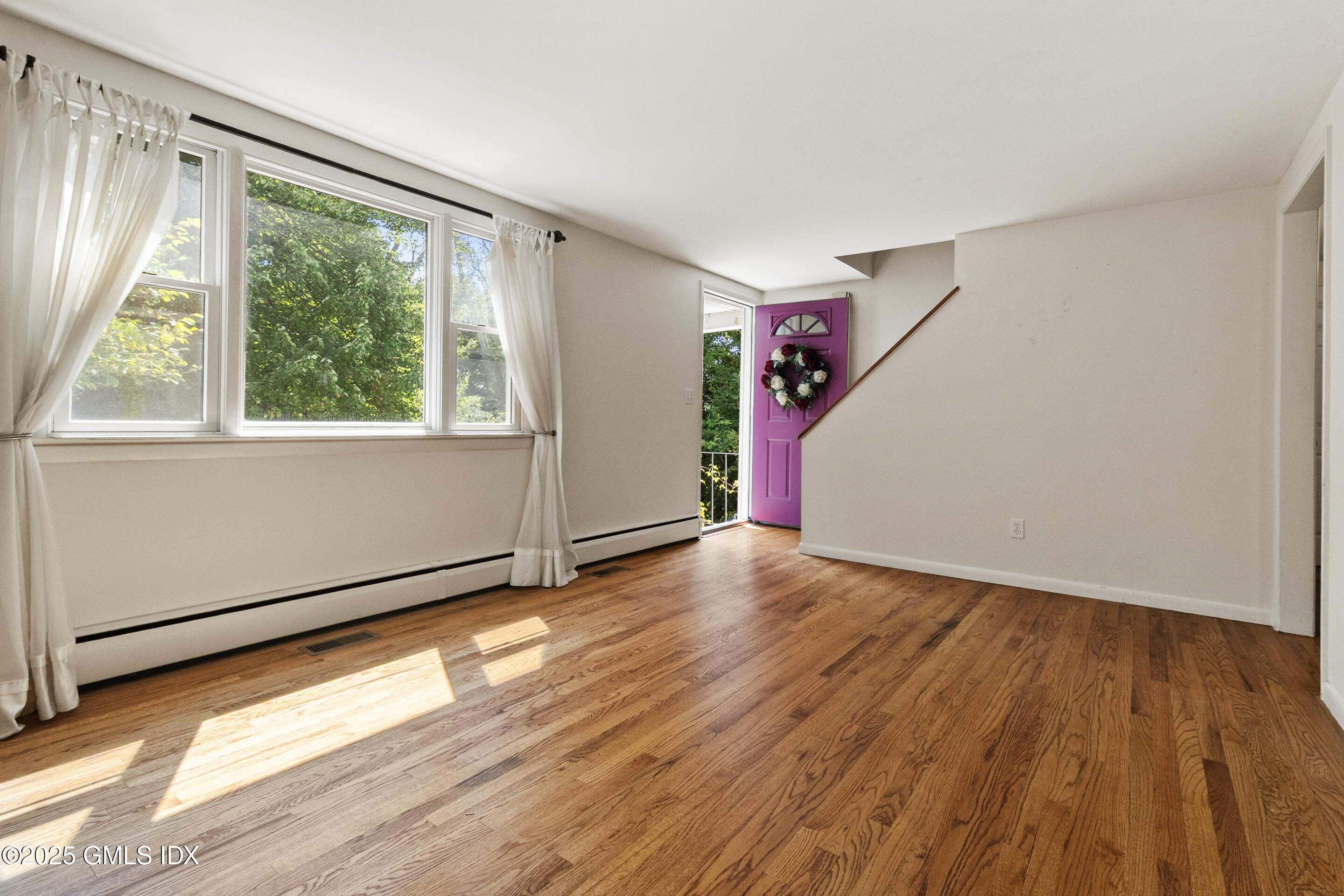 17 Cornwall Road Norwalk, CT 06850 - Photo 7 of 28 a view of an empty room with wooden floor and a window