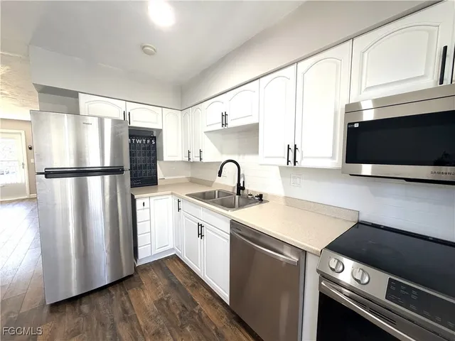 a kitchen with stainless steel appliances a refrigerator stove and microwave