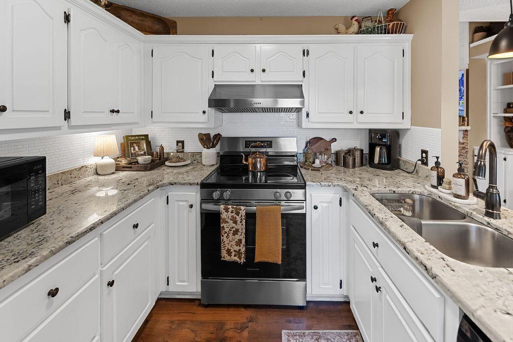 603 Cutoff Road Jasper, GA 30143 - Photo 12 of 24 a kitchen with granite countertop a stove sink and cabinets