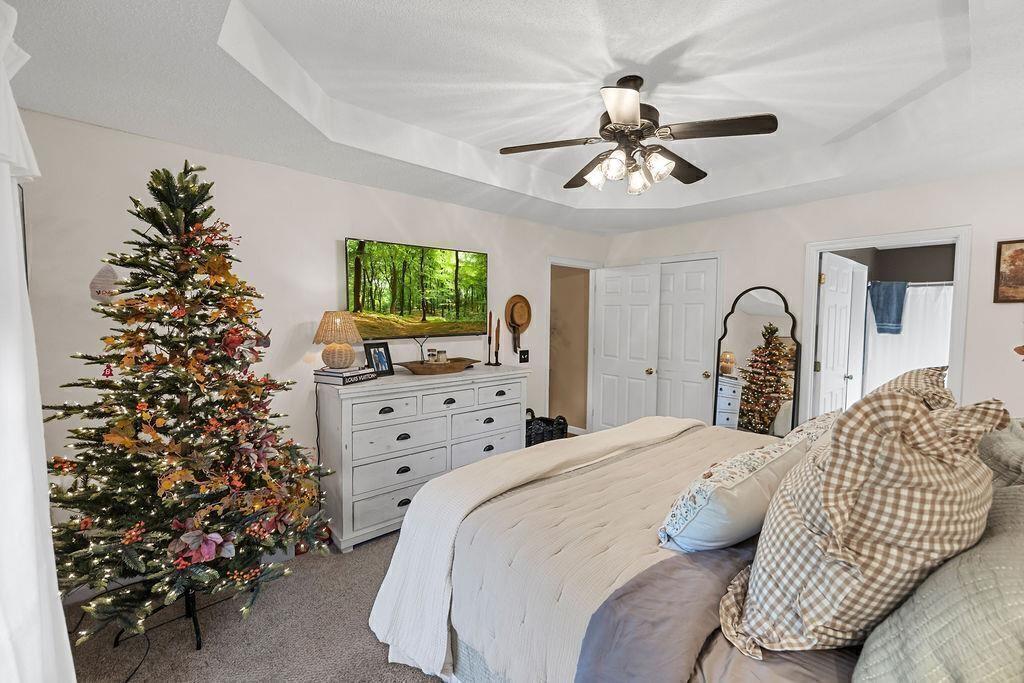 603 Cutoff Road Jasper, GA 30143 - Photo 14 of 24 a bedroom with a bed and a chandelier