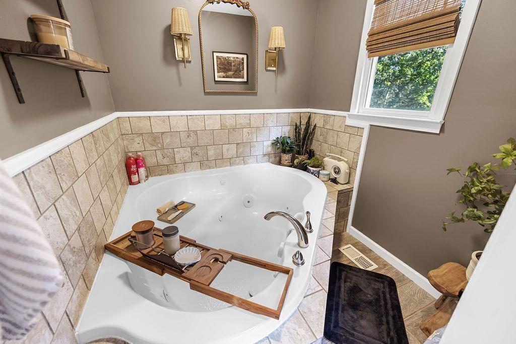 603 Cutoff Road Jasper, GA 30143 - Photo 16 of 24 a bathroom with a bathtub and a window