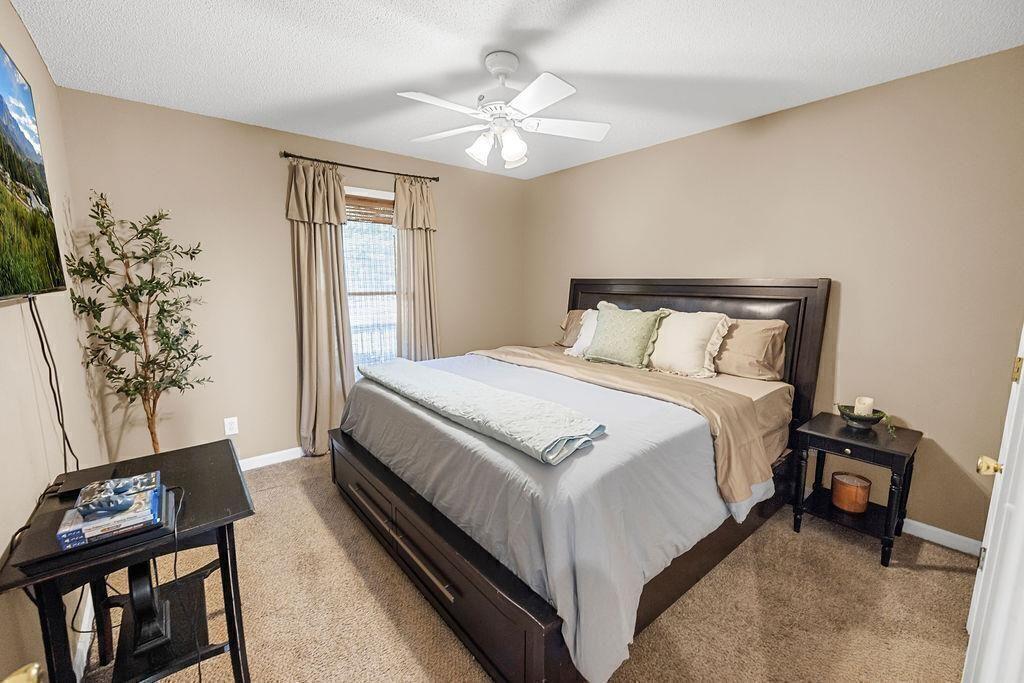 603 Cutoff Road Jasper, GA 30143 - Photo 17 of 24 a bedroom with a bed and a chandelier