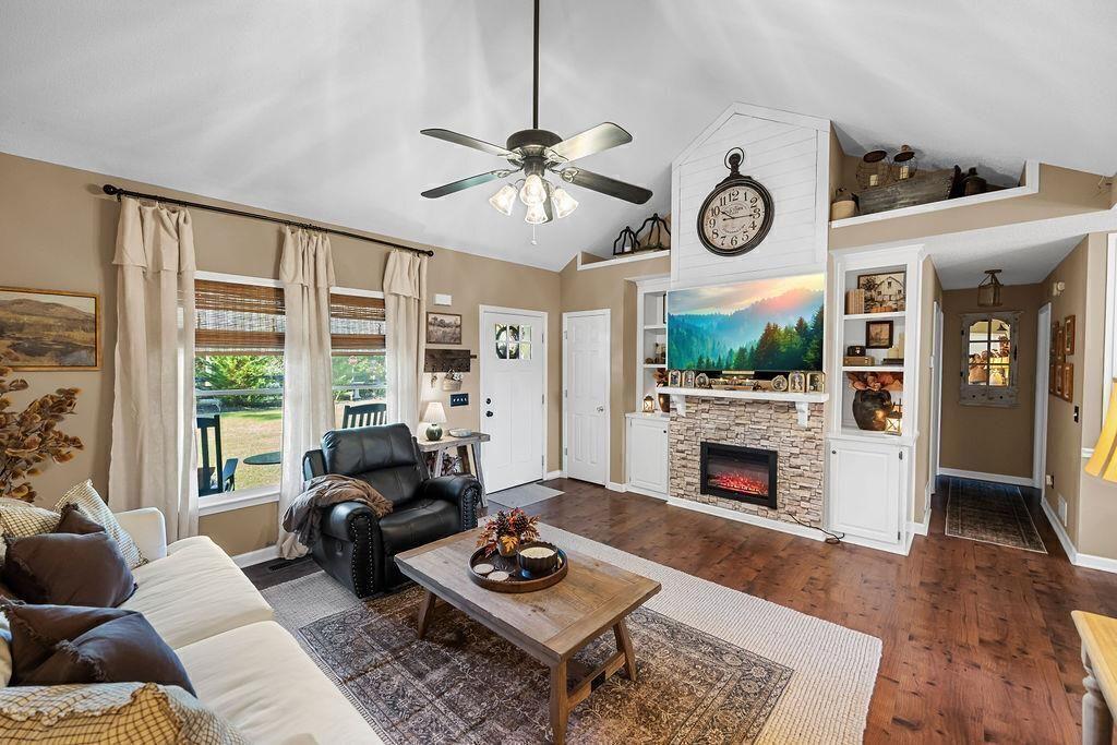 603 Cutoff Road Jasper, GA 30143 - Photo 5 of 24 a living room with furniture a fireplace a flat screen tv and a large window