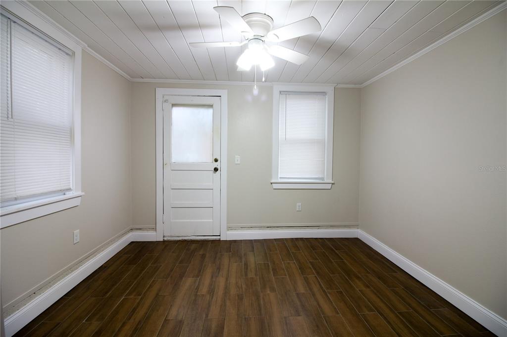 1123 South Tennessee Avenue Lakeland, FL 33803 - Photo 11 of 12 wooden floor in an empty room with a window