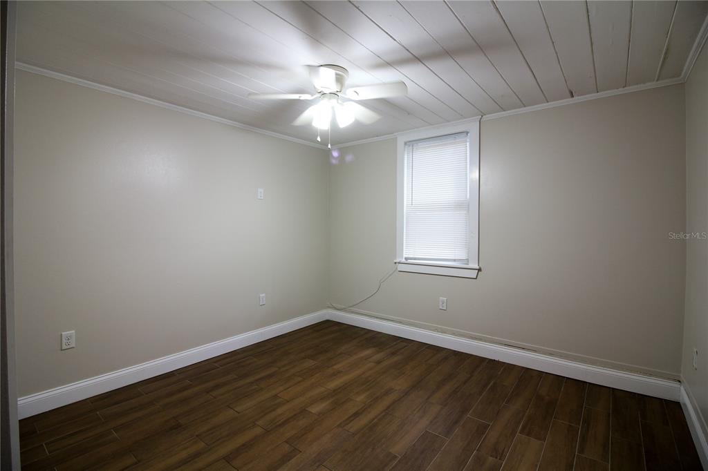 1123 South Tennessee Avenue Lakeland, FL 33803 - Photo 8 of 12 wooden floor in an empty room with a window
