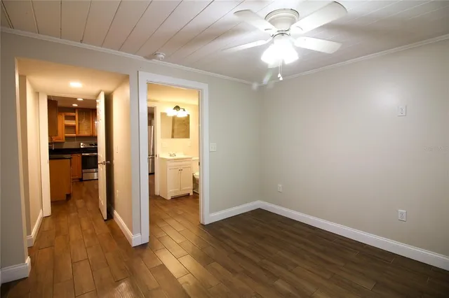 wooden floor in an empty room with a bathroom