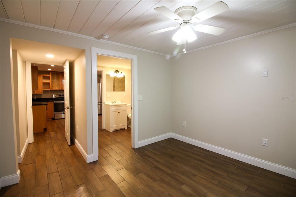 1123 South Tennessee Avenue Lakeland, FL 33803 - Photo 9 of 12 wooden floor in an empty room with a bathroom
