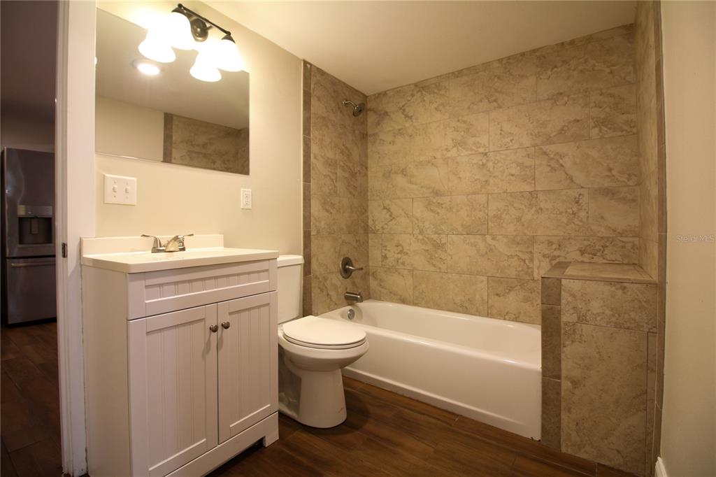 1123 South Tennessee Avenue Lakeland, FL 33803 - Photo 10 of 12 a bathroom with a sink a toilet and a bathtub