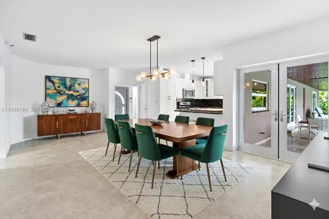 a view of a dining room with furniture and chandelier