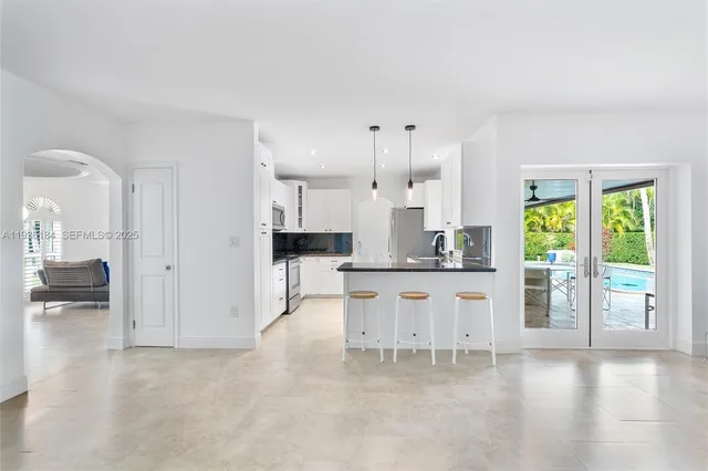 a large white kitchen with white cabinets and a stove