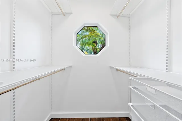 a view of staircase with white walls and a window