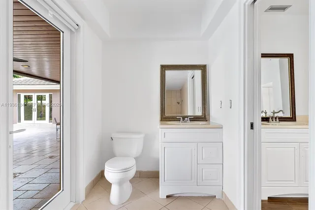 a bathroom with a toilet a sink and a window