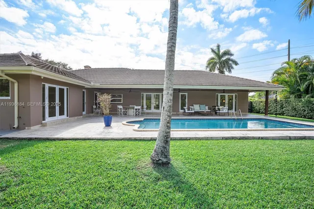 a front view of a house with a yard and patio