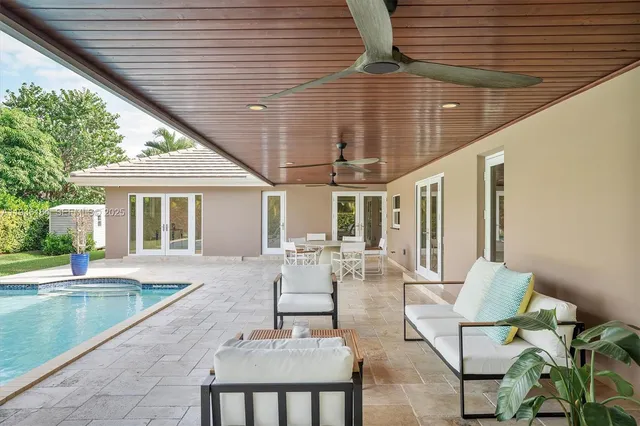 a view of house with backyard and outdoor seating