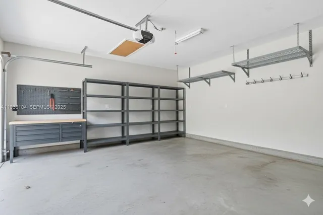 a view of an empty room with a ceiling fan