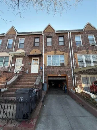 a view of a brick house with many windows